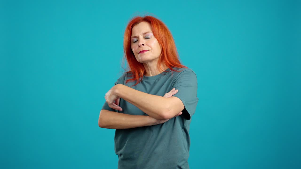 Serious woman with crossed arms looking at camera