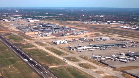 aerial view of london heathrow airport over runway 09l to the control tower and terminals 1, 2 and 3