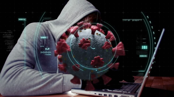 Animation of of macro covid19 cell over man wearing hoodie, using a laptop