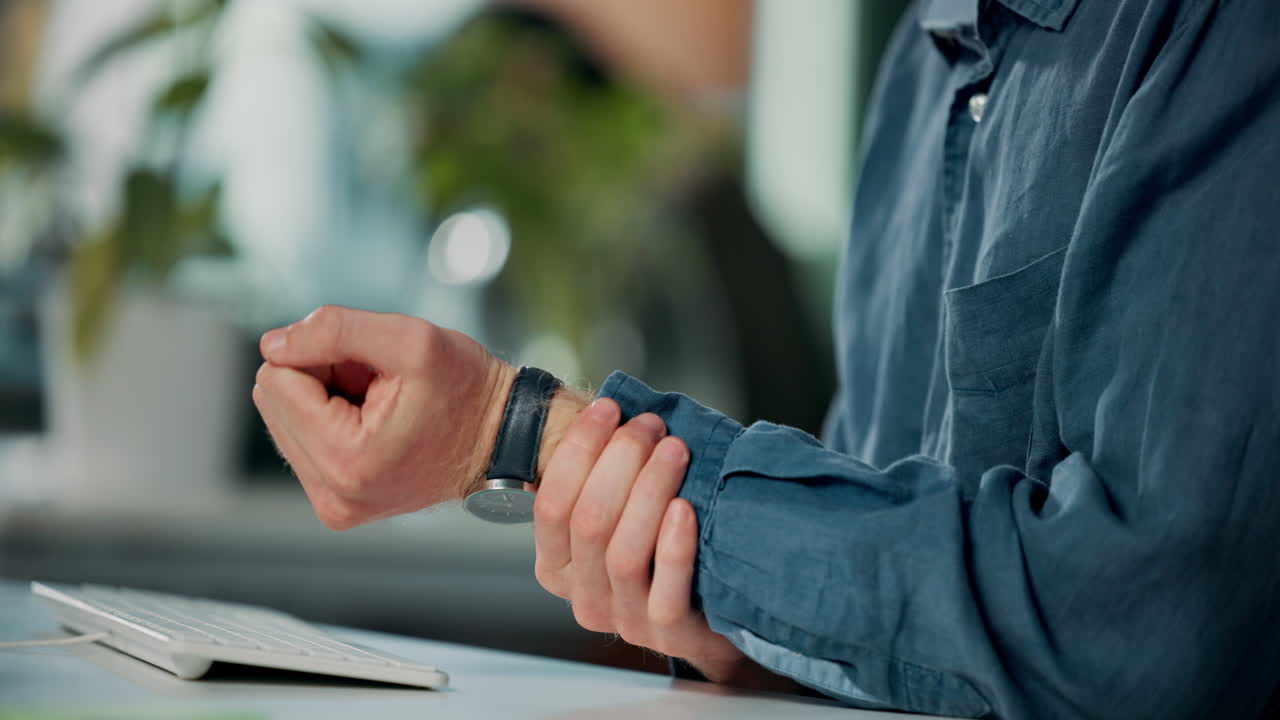 Man experiencing wrist pain while working at desk
