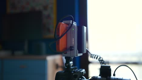 Closeup-slow-motion-shot-of-video-making-monitor-gear-on-a-DSLR-camera,-dolly-in