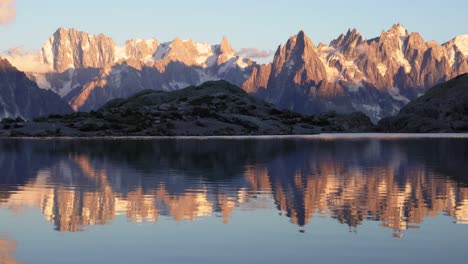 a stunning and colorful sunset view of monte bianco mountain range and the amazing lac blanc lake in the france alps of europe