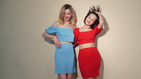 two women in trendy outfits