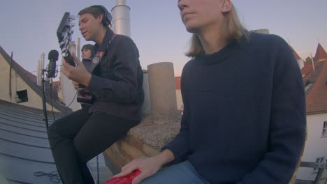 making music, the band makes a new song using musical instruments.