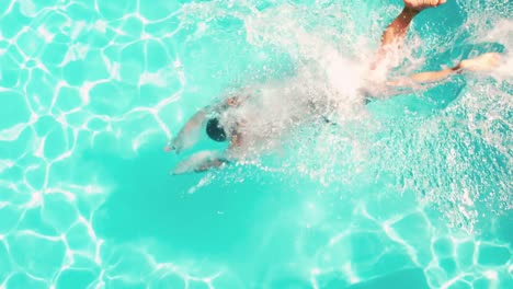 Athletic-man-diving-in-the-swimming-pool