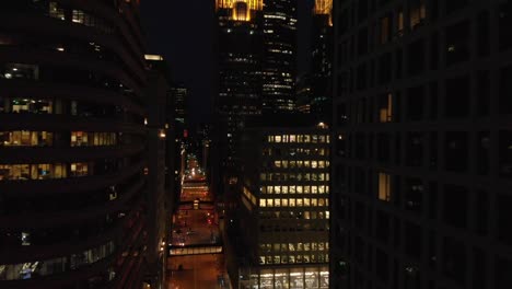 Cinematic-aerial-footage-of-downtown-minneapolis-at-night,-flying-between-buildings