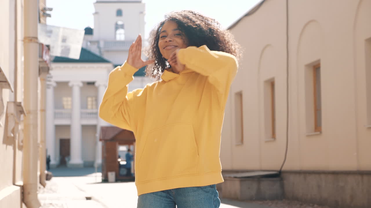 Young Woman Posing in a Yellow Hoodie