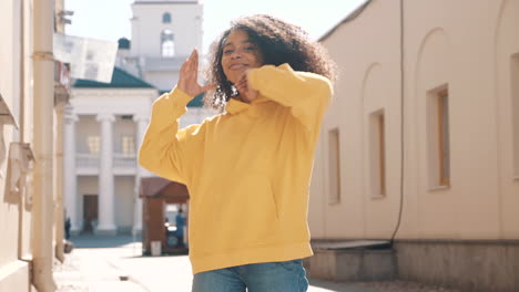 young woman posing in a yellow hoodie