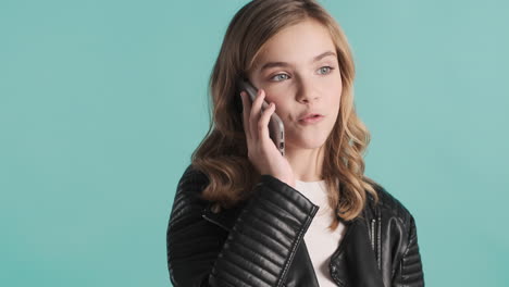 Teenage-Caucasian-girl-in-leather-jacket-having-a-phone-call.