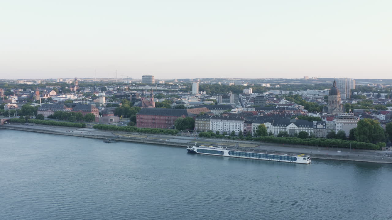 Aerial circling drone View of Mainz ship Rhine River, Castle, dom, Theodor Heuss Bridge and Cityscape at Sunset Germany 4k