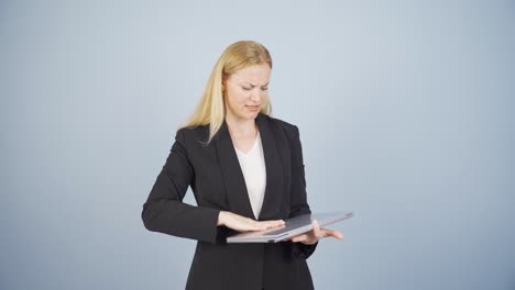 an angry business woman angrily closes her laptop.