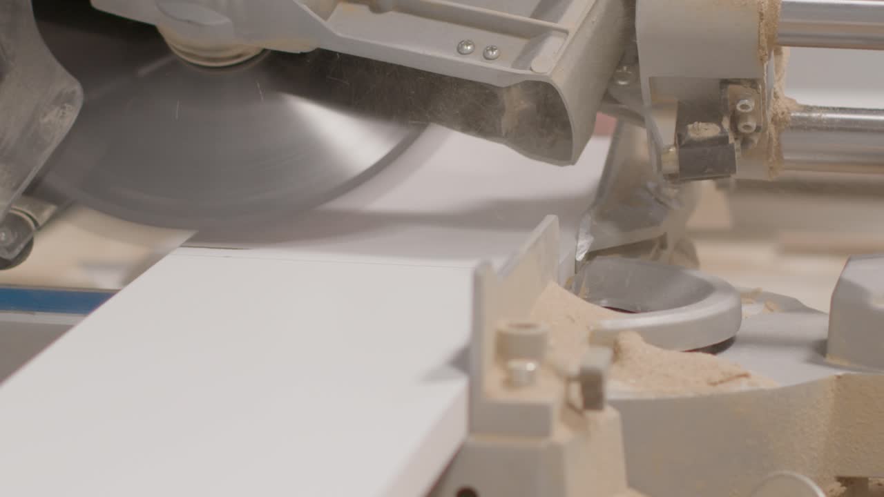 Extreme Close Up Shot of a Mitre Saw Cutting Skirting Board
