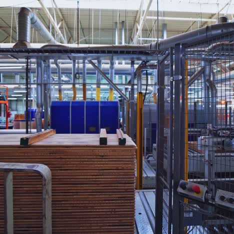 industrial wood processing factory with stacks of lumber and machinery