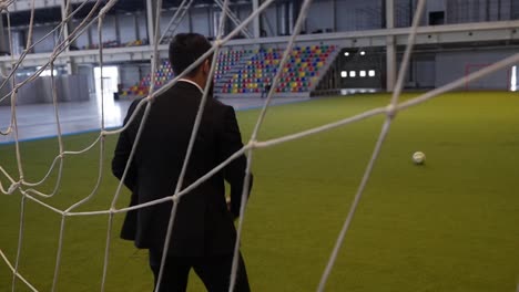 businessman observing a soccer match in an indoor stadium