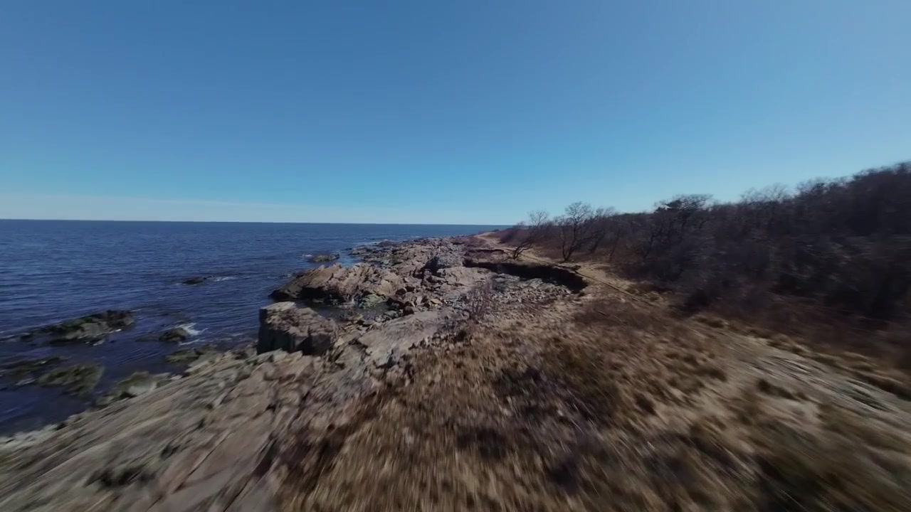 Rocky Seacoast Of New Hampshire With Blue Sky In The United States. FPV Shot