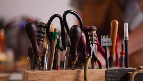 Traditional-tools-for-leather-processing-on-wooden-rack