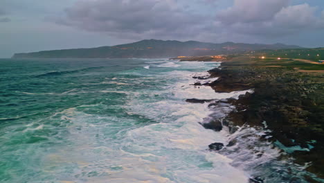dramatic coastal scene turbulent waves breaking on stone shore. rocky coast