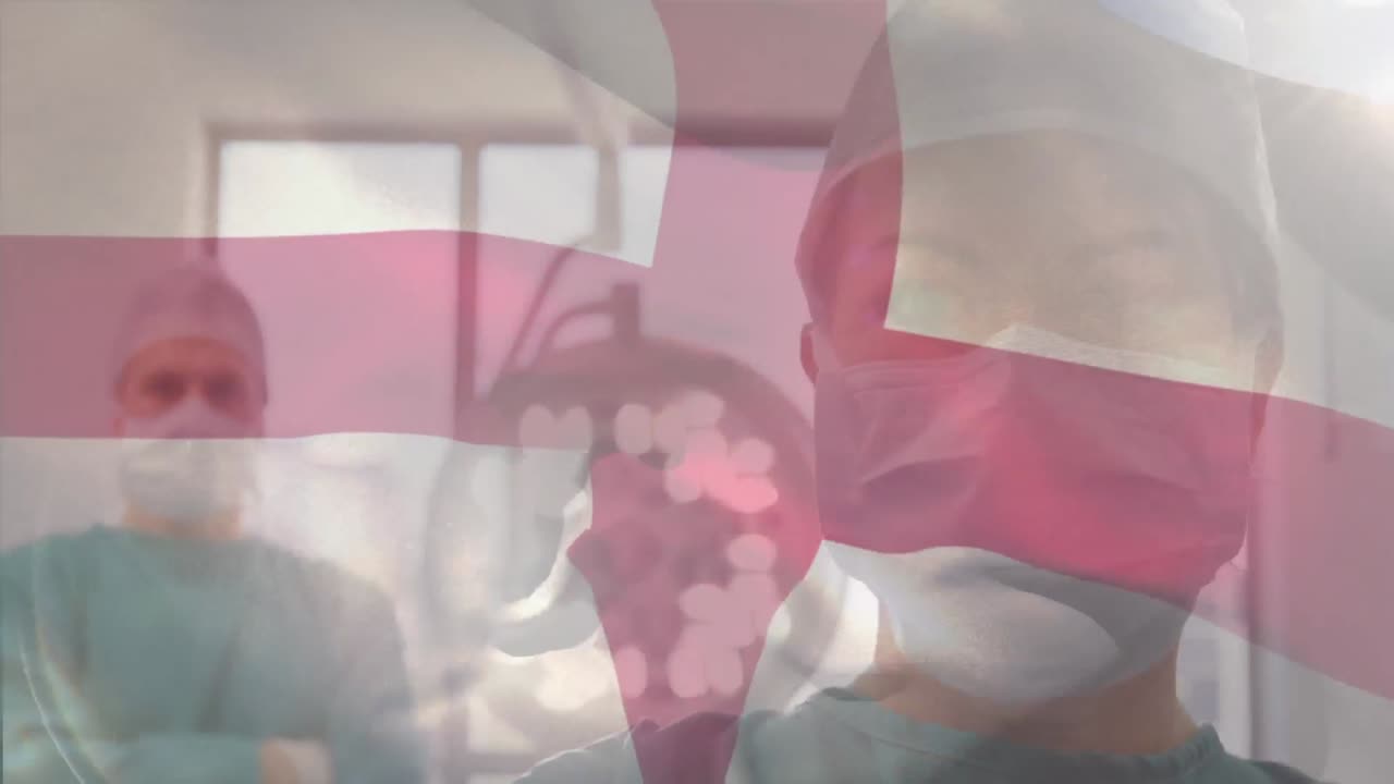 animación de la bandera de inglaterra ondeando sobre los cirujanos en el quirófano