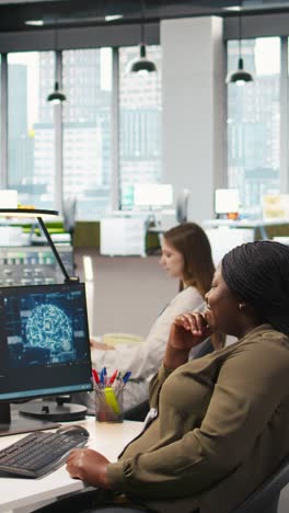 vertical video computer scientist in startup office reviewing ai system metrics