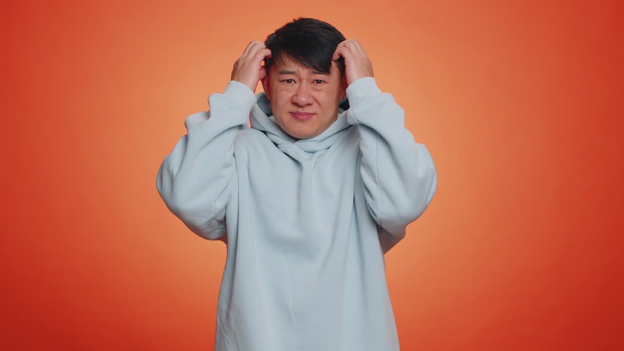 Puzzled clueless uncertain man raising hands in helpless embarrassed confused by difficult question