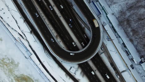 aerial view highway junction in winter city. cars moving on flyover intersection