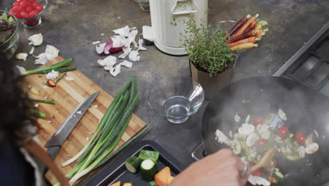 biracial woman preparing meal in kitchen, slow motion