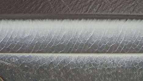 close up view of water spilling over the upper coliban reservoir spillway, central victoria, australia. october, 2022.