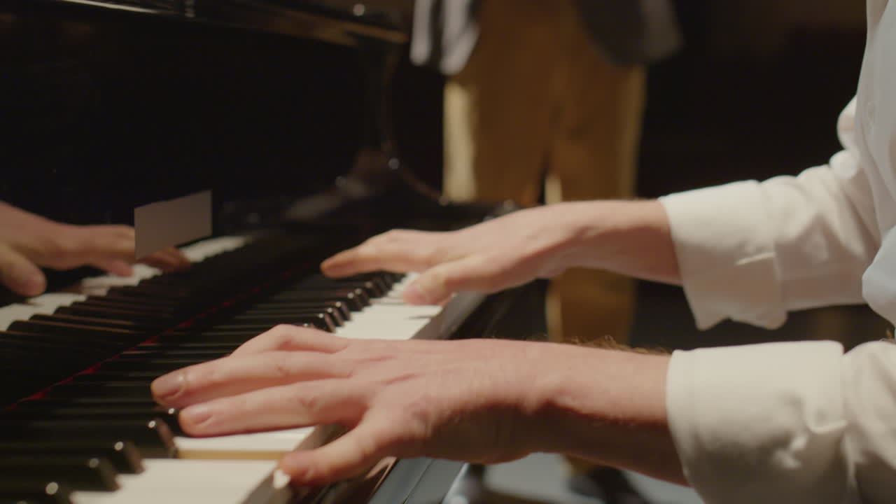 Piano Player Performing on Stage with Violinist