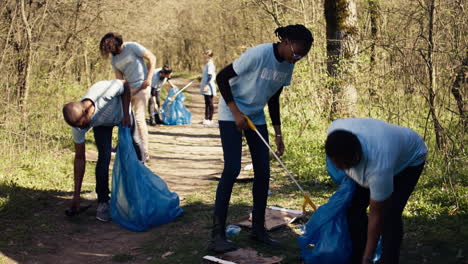 environmental activists collecting rubbish and plastic waste in garbage bag