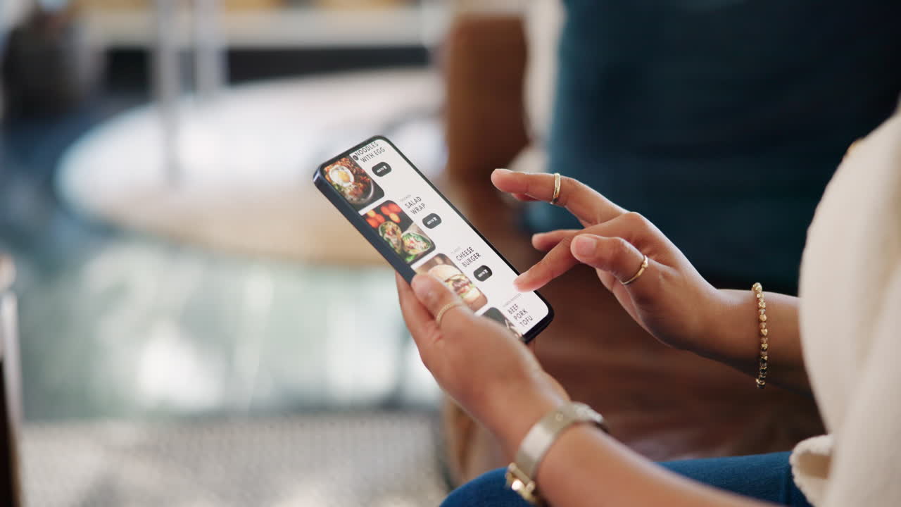 Person Scrolling Through Food Delivery App on Smartphone
