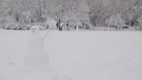 snowman in the public park on a snowy day