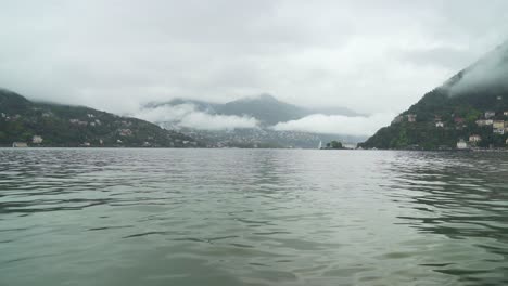 two coasts of como lake covered with low hanging clouds
