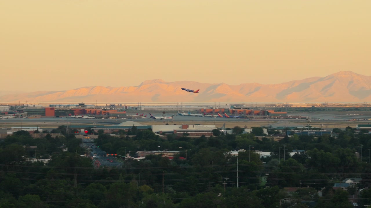 Airplane Takeoff at Salt Lake City International Airport Utah Sunrise Panning Left