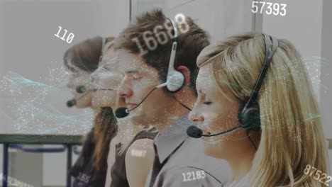 Animation-of-numbers-changing-over-business-people-using-phone-headsets