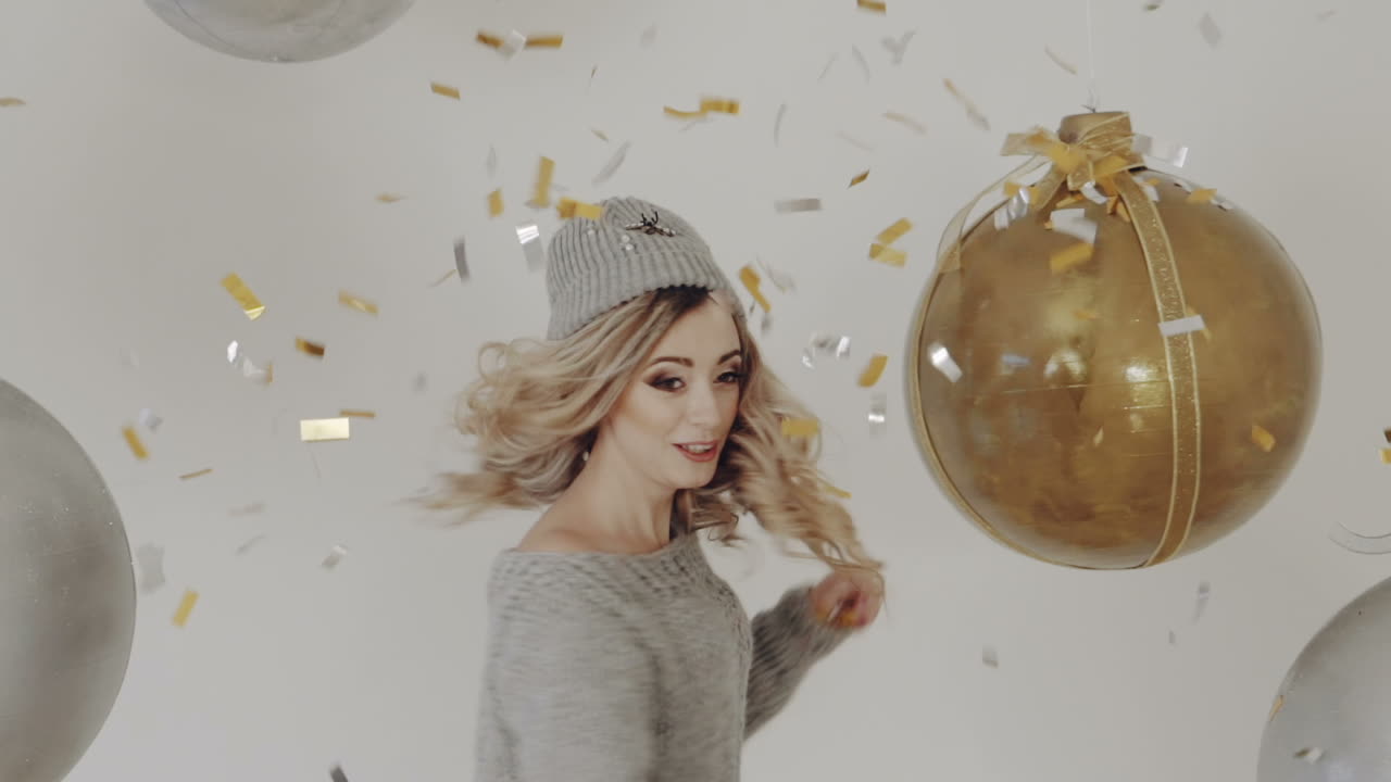 Woman showered with confetti. Young woman having fun and enjoy with colorful confetti