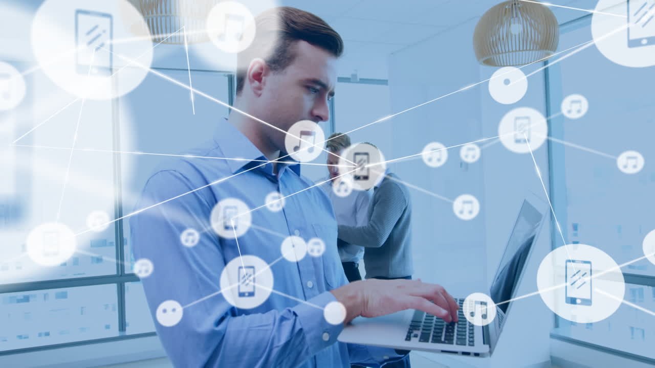 Using laptop with animation of digital music and phone icons, businessman working