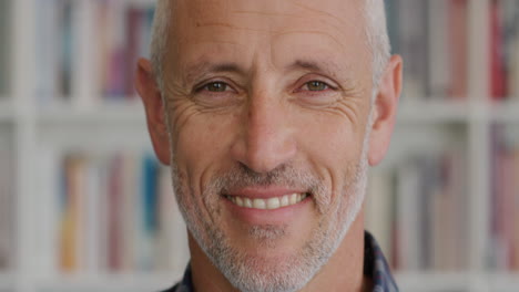 Close-up-portrait-mature-man-smiling-in-fornt-of-bookshelf