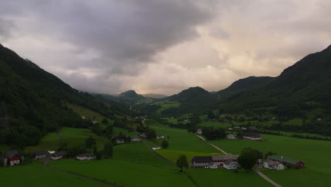 Dramatic-sky-over-small-settlement-and-houses,-rural-Norway