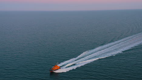 aerial view, shot in 4k, following a life boat, rnli, on a training mission