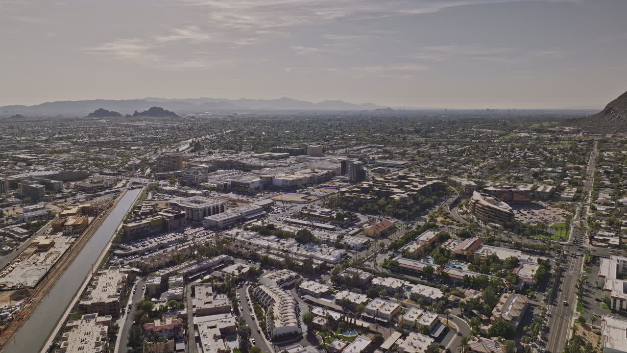 Scottsdale Arizona Aerial v6 drone flyover neighborhood along Arizona canal capturing downtown cityscape, panning reveals Camelback mountain and desert views - Shot with Mavic 3 Cine - February 2022