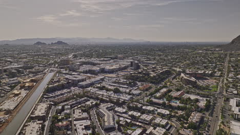 scottsdale arizona aerial v6 drone flyover neighborhood along arizona canal capturing downtown cityscape, panning reveals camelback mountain and desert views - shot with mavic 3 cine - february 2022