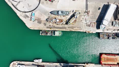 Aerial-Drone-shot-flying-slowly-forward-with-a-top-down-view-of-ships-in-a-boat-yard