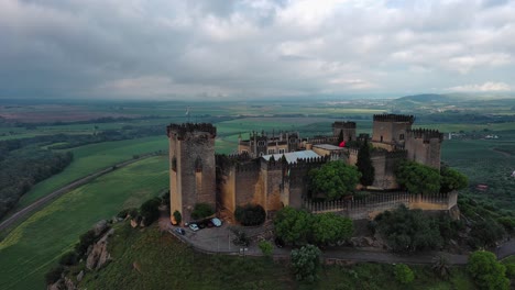 splendid drone view of almodovar del rio castle on cloudy day, cordoba