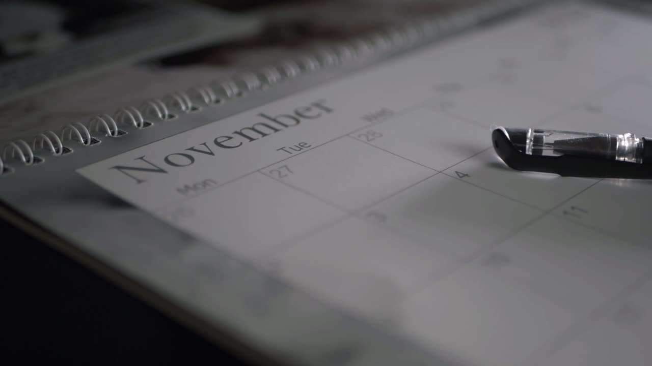 November calendar and pen close up panning shot