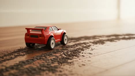 a bright red toy car leaving trails on a wooden floor, showcasing its speed and motion while kicking up dust in a playful environment