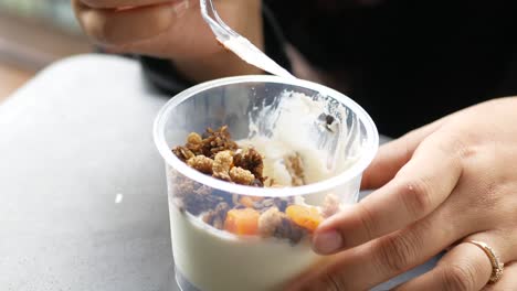 woman eating yogurt parfait