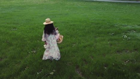 black woman with basket walking in park followed