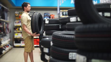 man shopping for tires in an auto parts store