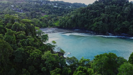 drone fly above scenic wild beach in costa rica central america revealing stunning natural seascape and rain forest jungle