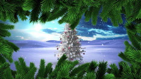 green christmas branches over snow falling over christmas tree on winter landscape